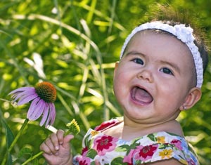 Smiling toddler with flower
