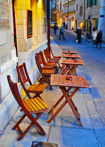 Outdoor cafe tables in a narrow street