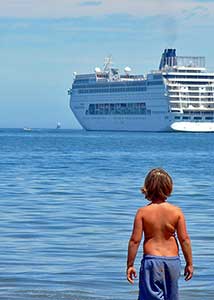 Kid looking at cruise ship
