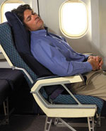 Man sleeping on airplane with inflateable sleeper for back support