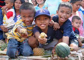 Kids in Surin Thailand offering fruits