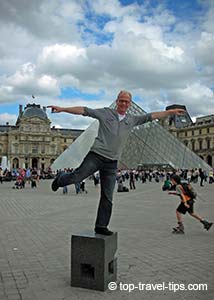 Man standing in front Louvre main entrance