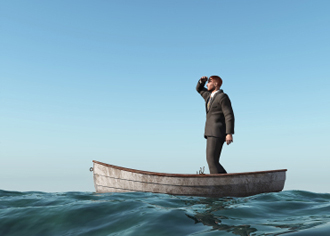 Man standing on a boat looking into the distance