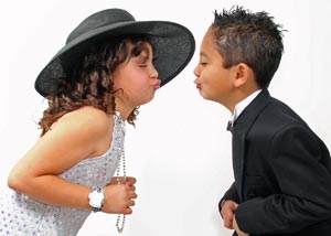 Two kids dressed up about kissing each other