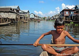Young boy in his boat in floating village Thailand