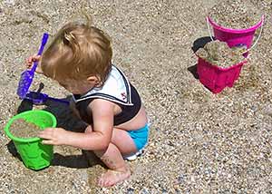Toddler playing on sandy beach