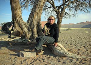 Asa Gislason owner of top-travel-tips.com emptying sand from her shoe in Namibia