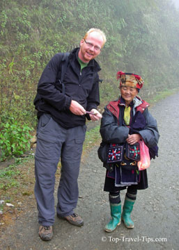 Man travelling solo talking to an old lady in Vietnam